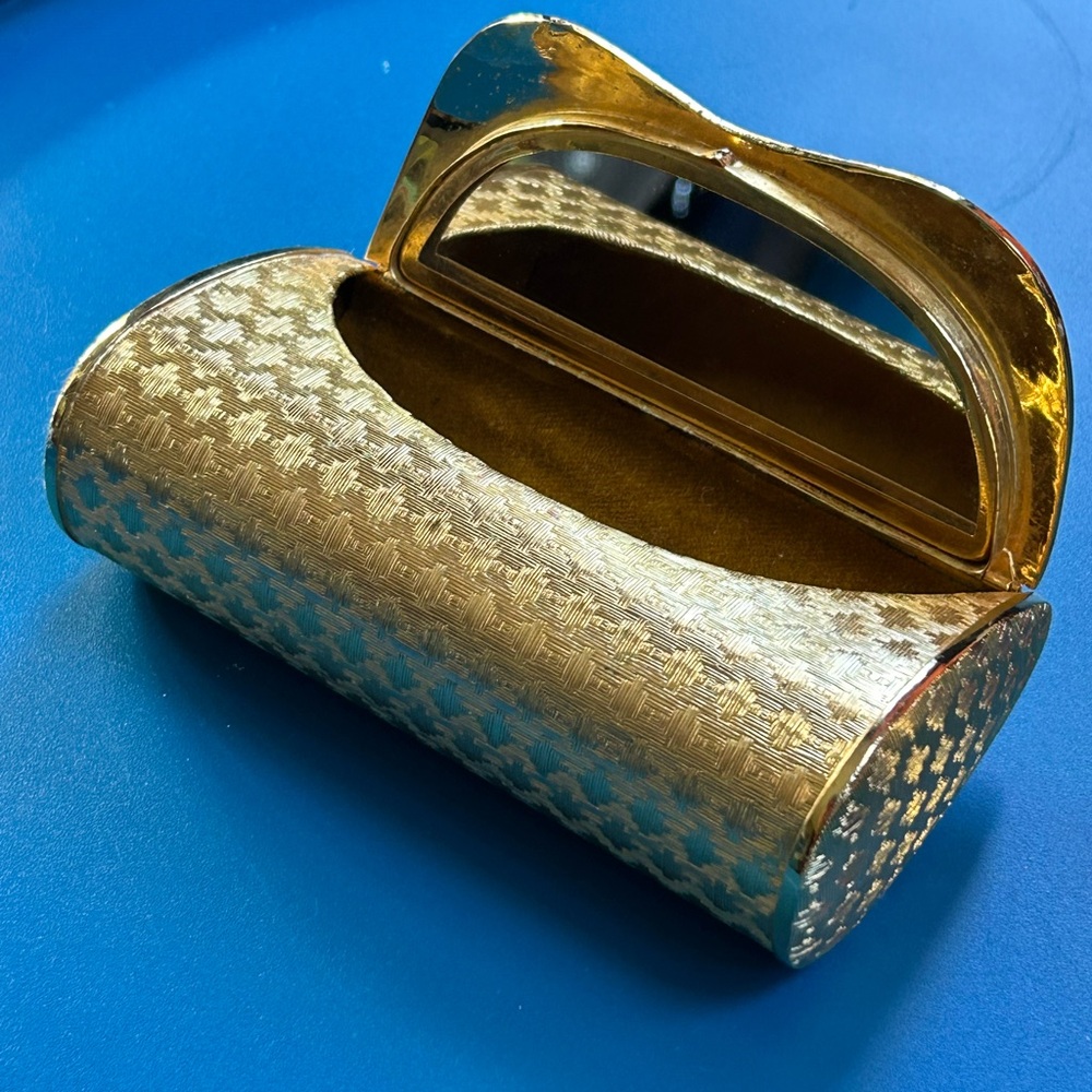 Vintage gold-tone metal compact case with geometric pattern and mirror